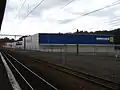 Neighbouring big-format retailers at Upper Hutt railway station, from foreground to background: Briscoes, Wellington Beds, Big Save Furniture, Mitre 10 Mega