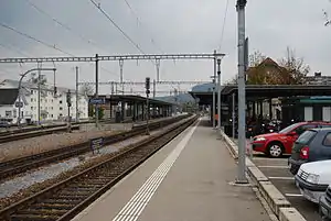 Double-tracked railway line flanked by platforms