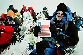 At Everest summit with Texas Flag, 2010