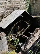 Photograph of the water wheel of Chez Lyonnet mill in operation.