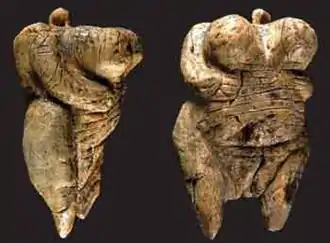 Two views of the Venus of Hohle Fels figurine, 40,000 BC-35,000 BC (6&nbsp;cm (2.4&nbsp;in) tall), one of the earliest known, undisputed examples of a depiction of a human being