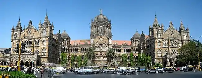 A brown building with clock towers, domes and pyramidal tops. Also a busiest railway station in India..mw-parser-output cite.citation{font-style:inherit;word-wrap:break-word}.mw-parser-output .citation q{quotes:"\"""\"""'""'"}.mw-parser-output .citation:target{background-color:rgba(0,127,255,0.133)}.mw-parser-output .id-lock-free a,.mw-parser-output .citation .cs1-lock-free a{background:url("//upload.wikimedia.org/wikipedia/commons/6/65/Lock-green.svg")right 0.1em center/9px no-repeat}.mw-parser-output .id-lock-limited a,.mw-parser-output .id-lock-registration a,.mw-parser-output .citation .cs1-lock-limited a,.mw-parser-output .citation .cs1-lock-registration a{background:url("//upload.wikimedia.org/wikipedia/commons/d/d6/Lock-gray-alt-2.svg")right 0.1em center/9px no-repeat}.mw-parser-output .id-lock-subscription a,.mw-parser-output .citation .cs1-lock-subscription a{background:url("//upload.wikimedia.org/wikipedia/commons/a/aa/Lock-red-alt-2.svg")right 0.1em center/9px no-repeat}.mw-parser-output .cs1-ws-icon a{background:url("//upload.wikimedia.org/wikipedia/commons/4/4c/Wikisource-logo.svg")right 0.1em center/12px no-repeat}.mw-parser-output .cs1-code{color:inherit;background:inherit;border:none;padding:inherit}.mw-parser-output .cs1-hidden-error{display:none;color:#d33}.mw-parser-output .cs1-visible-error{color:#d33}.mw-parser-output .cs1-maint{display:none;color:#3a3;margin-left:0.3em}.mw-parser-output .cs1-format{font-size:95%}.mw-parser-output .cs1-kern-left{padding-left:0.2em}.mw-parser-output .cs1-kern-right{padding-right:0.2em}.mw-parser-output .citation .mw-selflink{font-weight:inherit}"India's impressive railway stations". Rediff.com. 13 October 2011. Archived from the original on 18 May 2012. Retrieved 6 May 2012. A wide street in front of it