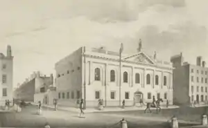 Neoclassical facade of the Royal College of Surgeons in Ireland with people walking