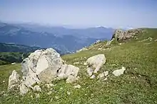 View of mountains with boulder in the foreground