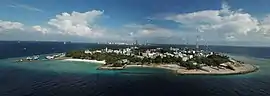 Aerial view of the whole of Villingili with Malé in the background,
