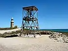 An old WWII radar tower with the Vlamingh Head Lighthouse behind