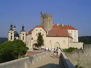 View from the west. In the middle is situated the Gothic watchtower upon the main gateway, on the left is the Holy Trinity Chapel with crypt of Althann family beneath