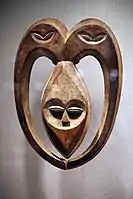 Kwele mask; 19th–20th century; wood coloured with kaolin; from Gabon or Democratic Republic of Congo; height: 52.7&nbsp;cm (20.mw-parser-output .frac{white-space:nowrap}.mw-parser-output .frac .num,.mw-parser-output .frac .den{font-size:80%;line-height:0;vertical-align:super}.mw-parser-output .frac .den{vertical-align:sub}.mw-parser-output .sr-only{border:0;clip:rect(0,0,0,0);clip-path:polygon(0px 0px,0px 0px,0px 0px);height:1px;margin:-1px;overflow:hidden;padding:0;position:absolute;width:1px}3⁄4 in.), width: 38.1&nbsp;cm (15 in.); depth: 10.2&nbsp;cm (4 in.); Metropolitan Museum of Art. This mask was used in the rituals of witchcraft protection