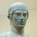 Charioteer of Delphi, wearing a fillet headband, bronze statue (478–474 BCE).