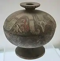 A painted pottery dou vessel with a dragon design from the Warring States period (403–221 BC)