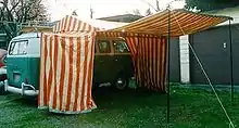VW bus with attached large tent