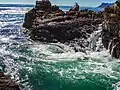 A whirlpool between the large rocks characteristic for the coast line
