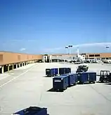 Tarmac with baggage handling equipment and an America West jet (1989)