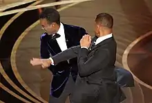 Chris Rock is slapped by Will Smith.