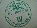 Exit stamp issued at Woodlands Train Checkpoint in a Malaysian Passport