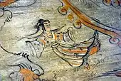Person flying in skies in tomb painting, an apsara?
