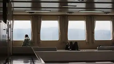 The inside of a passenger ferry on route between Shikoku and Kyushu. The number of actual seats is usually very limited on Japanese passenger ferries, with larger spaces dedicated to tatami or broadloom areas where passengers can sit or lie down