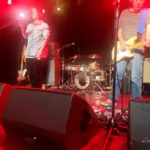 Hubley at a microphone and Kaplan with a guitar