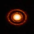 Protoplanetary disc AS 209 nestled in the young Ophiuchus star-forming region.