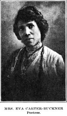 An African-American woman, her dark hair dressed up off her neck and shoulders; she is wearing a lace blouse with a high collar, and beads.