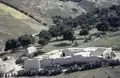 A white farm seen from above with a typical white washed triangular haystack, 1997.