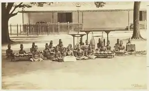 A Dalang (Puppeteer), Sindhen (singer) and Wiyaga (gamelan musicians) with Javanese Gamelan at Keraton Yogyakarta the Sultan's Palace in Yogyakarta - Around 1885