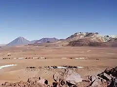 A view across the plains of Chajnantor with the ALMA construction site at the center.