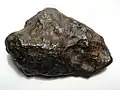 A 700-gram (25&nbsp;oz) individual Chinga iron meteorite (Ataxite, class IVB). This specimen is about 9 centimeters wide.
