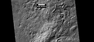 Surface showing large hollows of unknown origin, as seen by HiRISE under HiWish program.  The hollows may be the result of large amounts of ice leaving the ground.