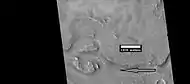 Close view of streamlined shapes, as seen by HiRISE under HiWish program Arrow indicates the direction of past flowing water.