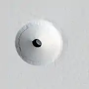 HiRISE image of a 35 m wide lava tube skylight surrounded by a collapse pit on Pavonis Mons