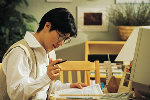 man paying bills at desk