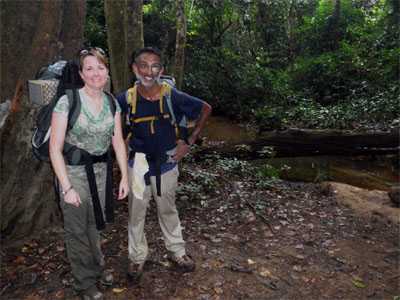 Satish and his colleague Laura hiking in the Liberian jungle on the way to a remote community with suspected Ebola cases.