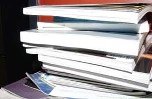 A pile of reading material on a table