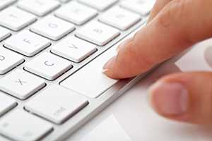 laptop keyboard with finger pressing on spacebar