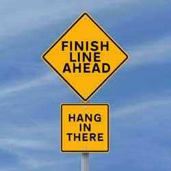 Sign that read Finish Line Ahead and Hang in There