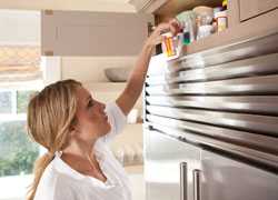 Woman reading pill bottle labels