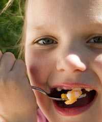 A child eating eggs