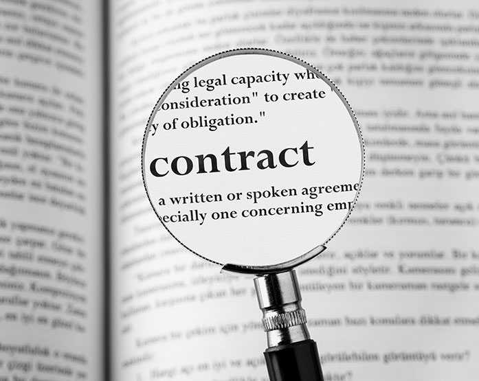 magnifyinmg glass over the word contract