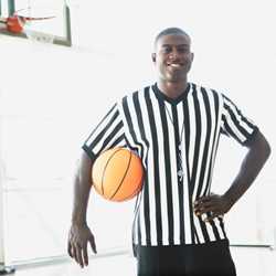 referee holding basketball