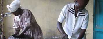 Photo: Two people with water jugs