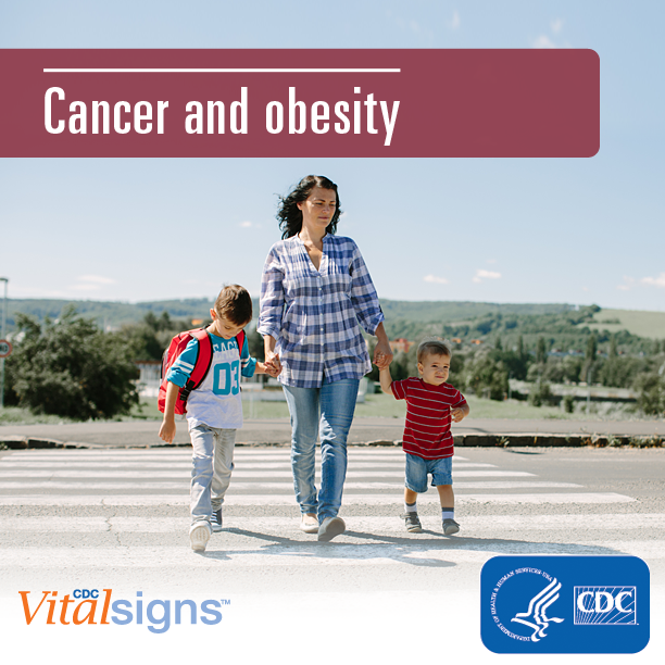 A woman walking her young children to school