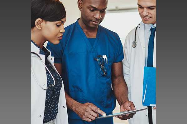 Physicians looking at a medical chart.