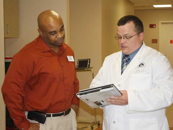 A physician and health care worker review an electronic screening system used at the Community Cancer Screening Program. The Cancer Coalition of South Georgia used Task Force recommendations to help develop a cancer screening program for breast, cervical and colorectal cancers. The program’s goal is to reduce cancer-related disparities in medically underserved Baker County. The program pilot started in Baker County and expanded to 12 primary care clinics serving more than 25 counties in South Georgia.