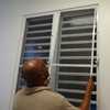 Man installs indoor window screens