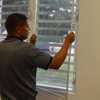 Man installs indoor window screens