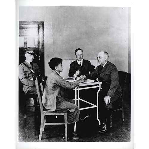 National Library of Medicine; photograph by P.E. Brooks - U.S. Public Health Service (PHS) and Immigration Service officers interrogating a Chinese immigrant, Angel Island, California, 1923 - Asian immigrants who arrived the first part of the 20th century received special scrutiny because they were considered disease carriers. The Asian community mounted many legal challenges to these practices.