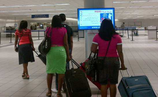 Small group walking with luggage in airport