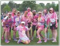 Photo of a group of runners posing in a group after the race