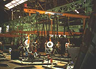 Wire welding units on overhead Jib Booms